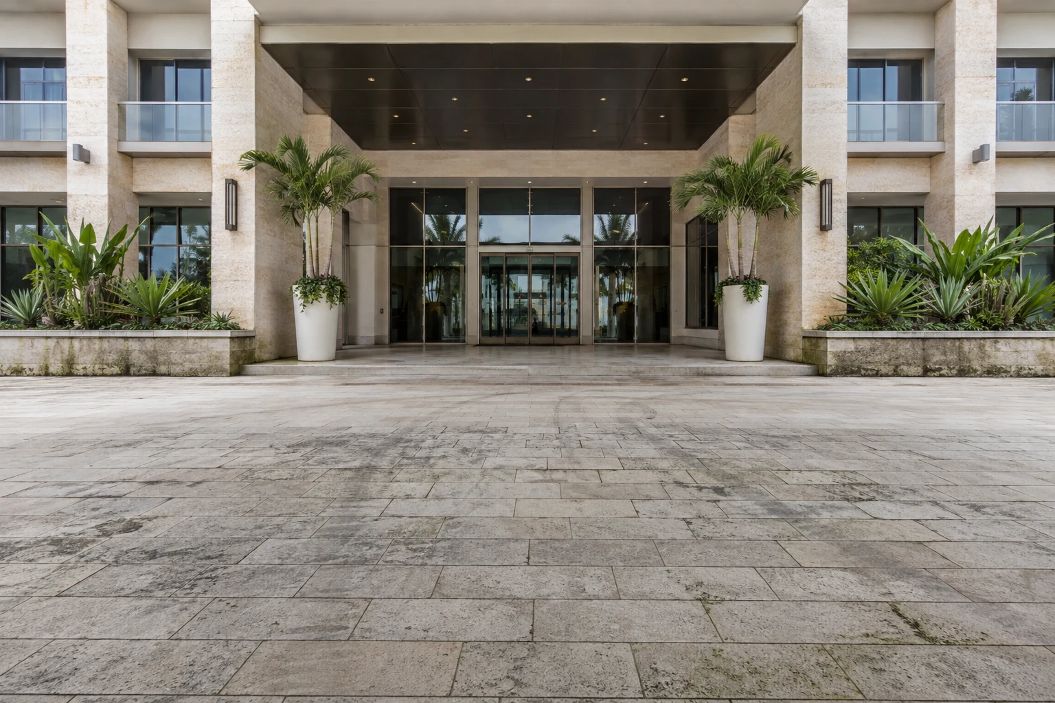 Miami hotel entrance and stone arrival plaza before exterior cleaning